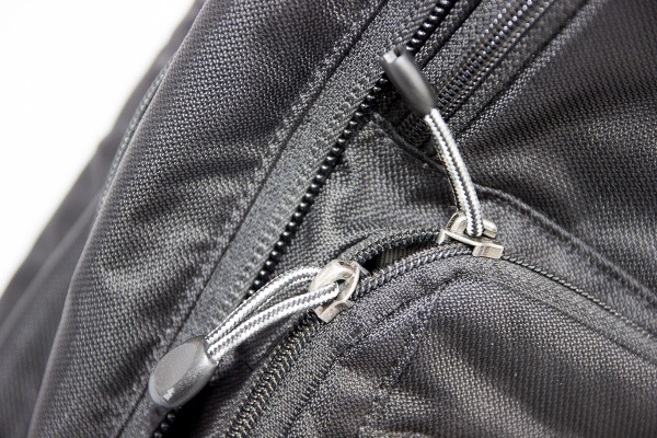 Two-way zippers should never meet on a corner where they may come apart as the bag is bounced and jostled.