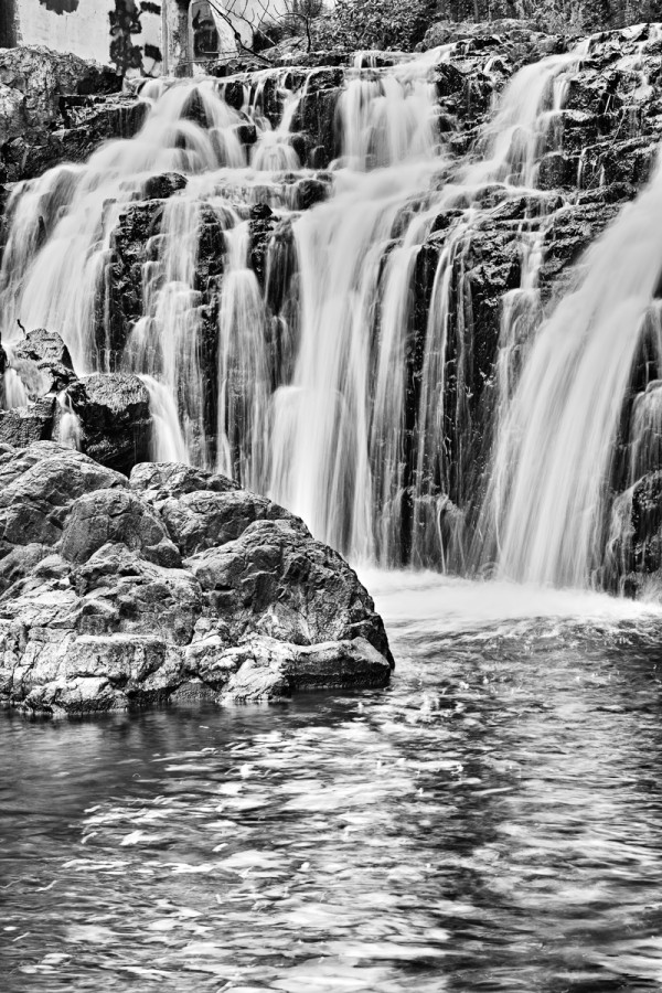 A low ISO, small F/13 aperture, and a polarizer filter were all selected to ensure a slow (4/10 second) shutter speed to add motion blur to the cascading water. A tripod or Optical Stabilizer is often necessary for long shutter speeds!