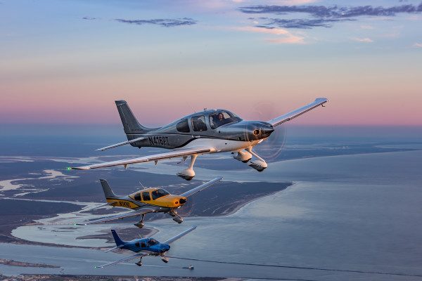 © 2016 Jim Koepnick | Three Cirrus SR22 aircraft in formation over Florida coast at dawn. Sigma 70-200 f2.8 lens at 1/80th of a second at f10 at ISO 400. Showing the horizon in this image gives a feeling of perspective.