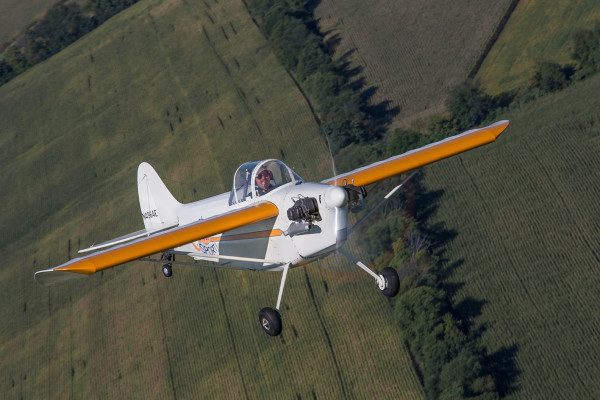 © 2016 Jim Koepnick | Bentzen Sport aircraft photographed near Brodhead, WI with a Sigma 70-200mm lens. This is a good example of photographing over a field without roads or buildings that might give a cluttered look.