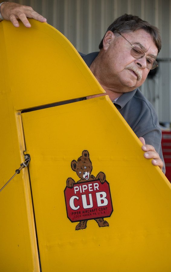 © 2016 Jim Koepnick | CubAir Flight owner Steve Krog of Hartford, Wisconsin, checks out the tail surfaces on one of his Piper Cubs. Sigma 18-300mm; Nikon D5; 1/320 sec at f5.3; ISO 400.